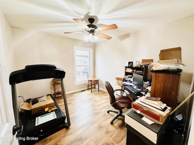 office featuring ceiling fan, baseboards, a textured ceiling, and wood finished floors