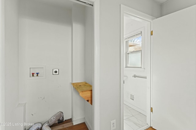 laundry area featuring marble finish floor, laundry area, washer hookup, and hookup for an electric dryer