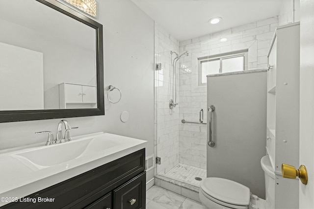 bathroom with baseboards, toilet, marble finish floor, vanity, and a shower stall