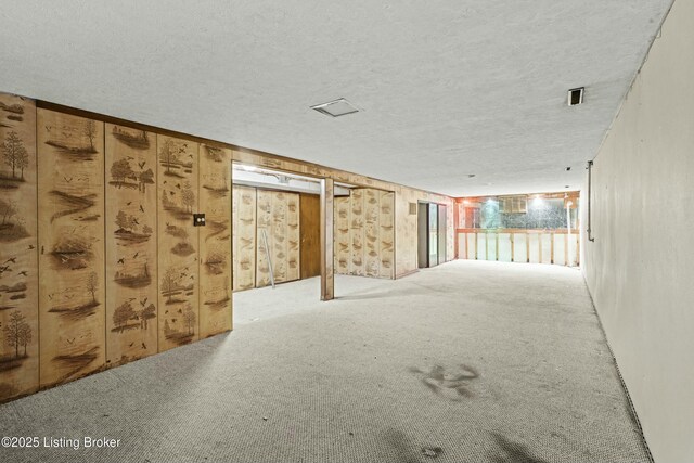 carpeted spare room featuring a textured ceiling