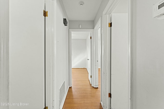 hallway with visible vents and light wood-style flooring