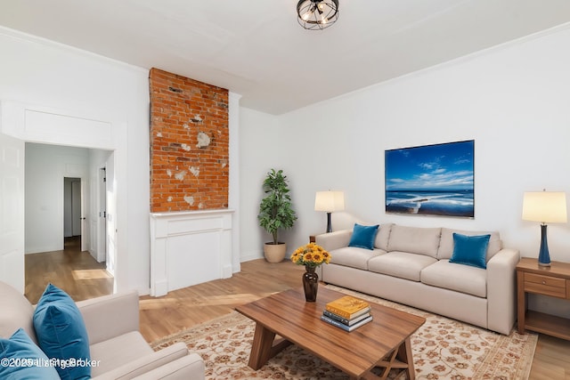 living area featuring wainscoting, crown molding, and wood finished floors