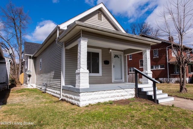 view of front of property with covered porch and a front yard