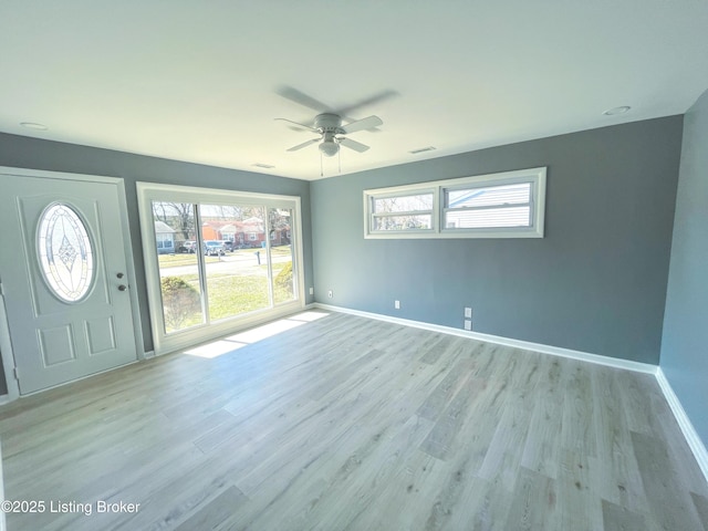 interior space featuring light wood-style flooring, visible vents, and baseboards