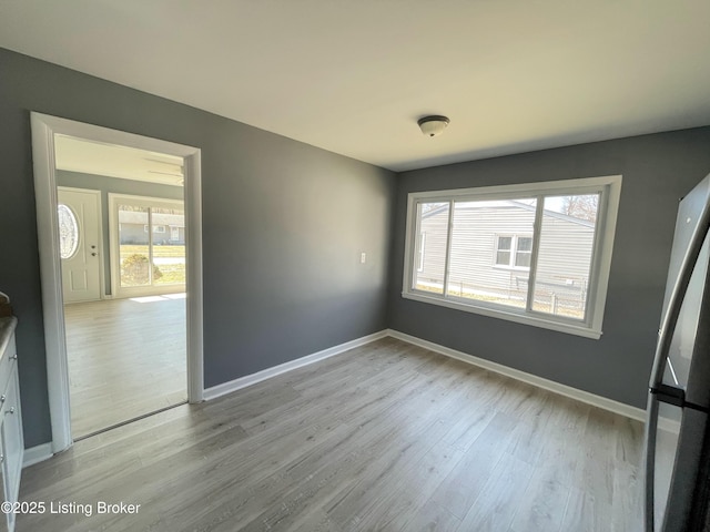 interior space featuring light wood finished floors and baseboards