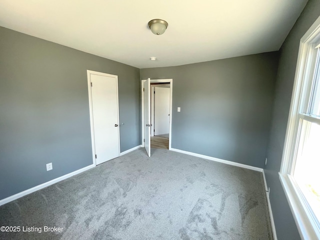 unfurnished bedroom with carpet and baseboards