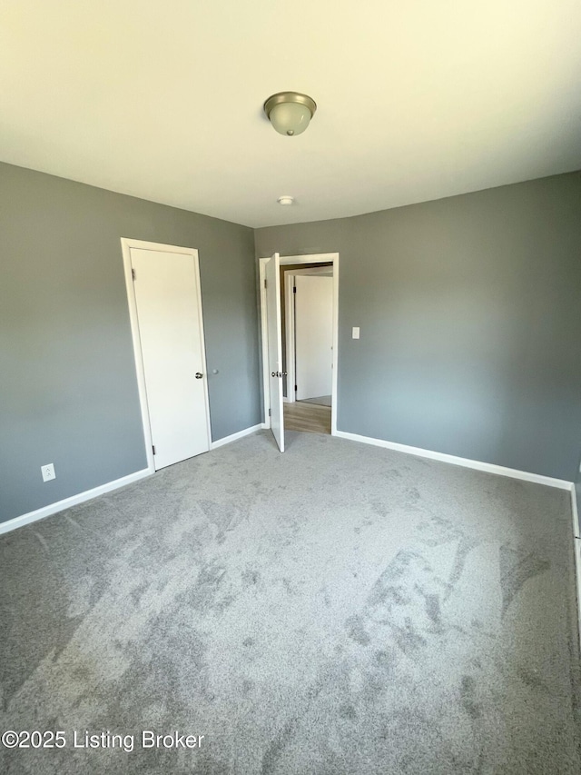 unfurnished bedroom with carpet and baseboards