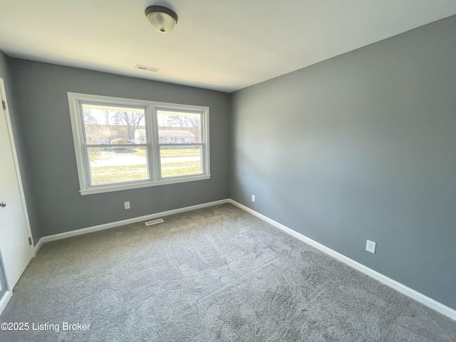 unfurnished room featuring carpet flooring, visible vents, and baseboards