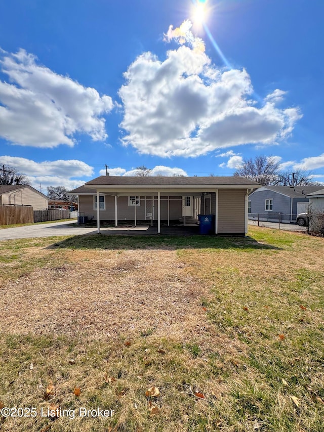 back of house with a yard and fence