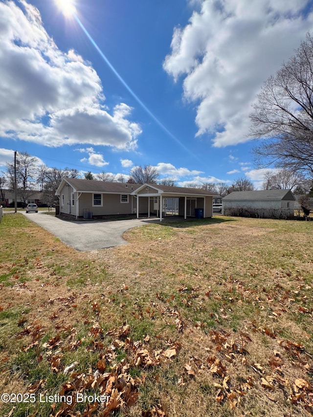 rear view of property featuring a lawn