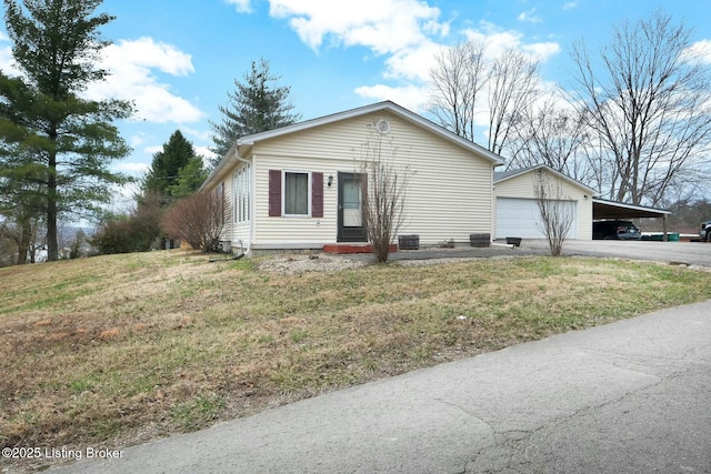 view of front facade with a garage, an outdoor structure, and a front yard