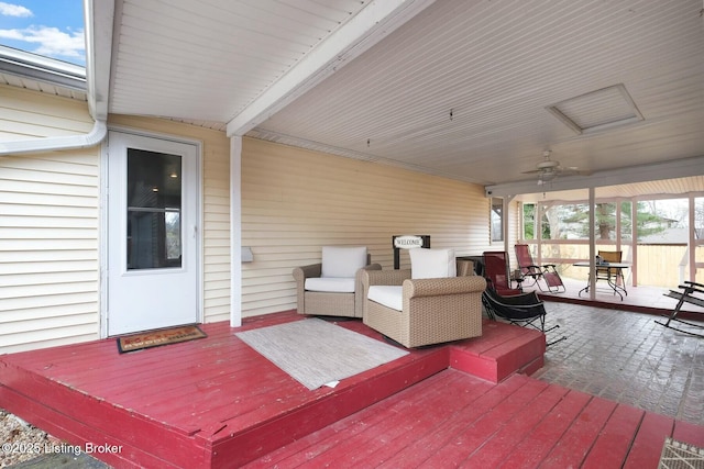 wooden deck with a ceiling fan