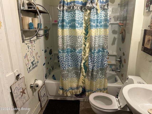 bathroom featuring shower / bath combo, a sink, toilet, and tile patterned floors