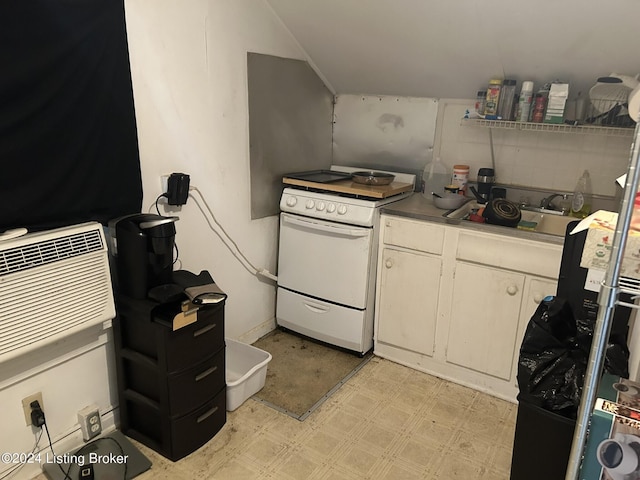 kitchen with light floors, white electric range oven, white cabinets, vaulted ceiling, and a sink