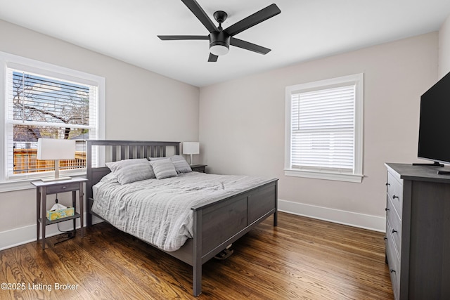 bedroom featuring baseboards, a ceiling fan, and dark wood finished floors