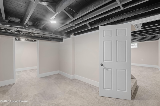 basement with carpet flooring and baseboards