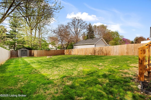 view of yard with a storage shed, a fenced backyard, and an outdoor structure