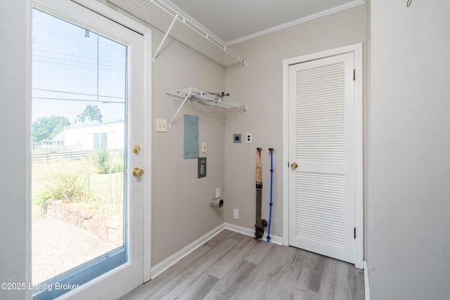 clothes washing area with laundry area, baseboards, light wood-style flooring, crown molding, and hookup for an electric dryer