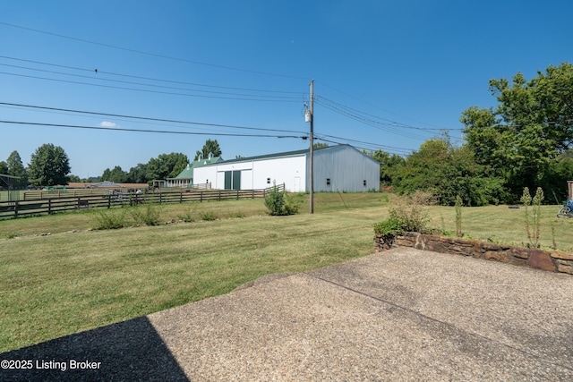 view of yard with fence and an outbuilding