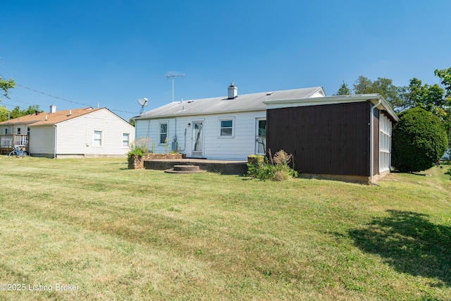 back of house with a yard