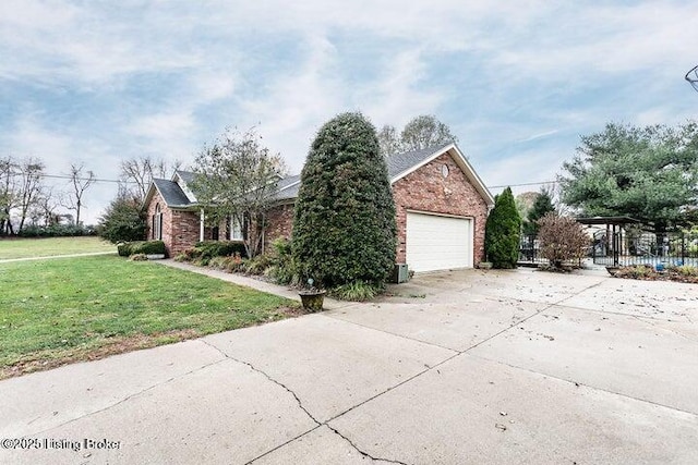 view of front facade featuring a garage, a front yard, fence, and brick siding