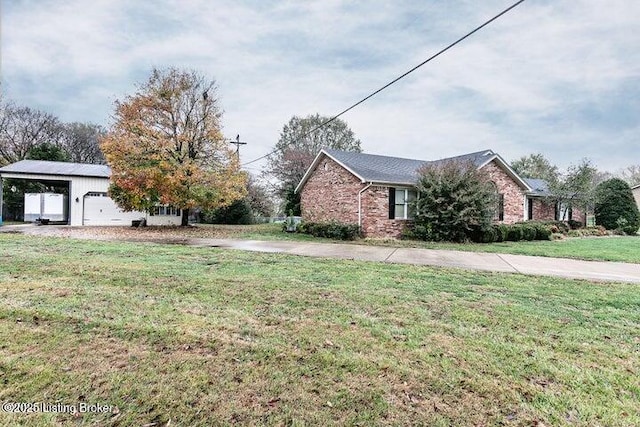 view of side of home with a carport, a yard, and brick siding