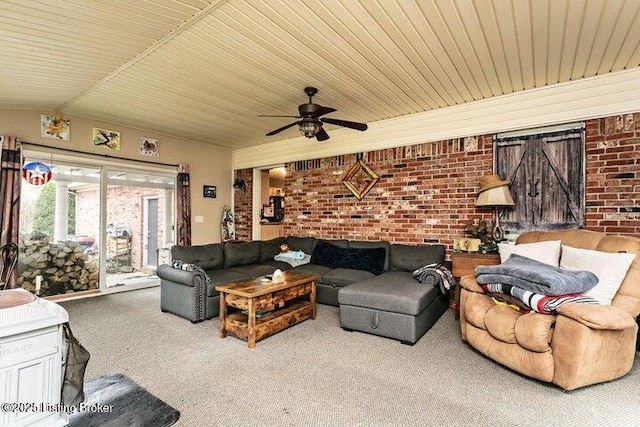 carpeted living area with brick wall and a ceiling fan