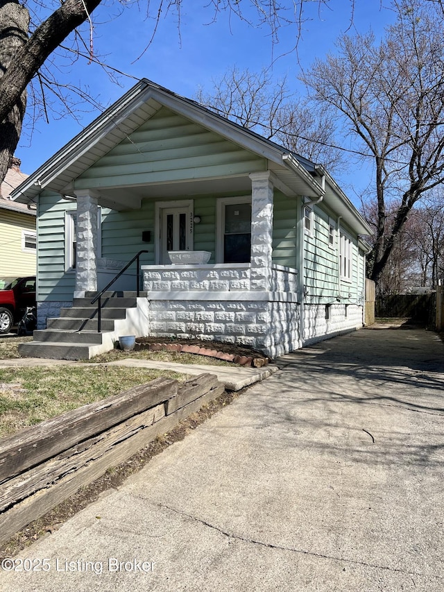 view of front of home with driveway and a porch