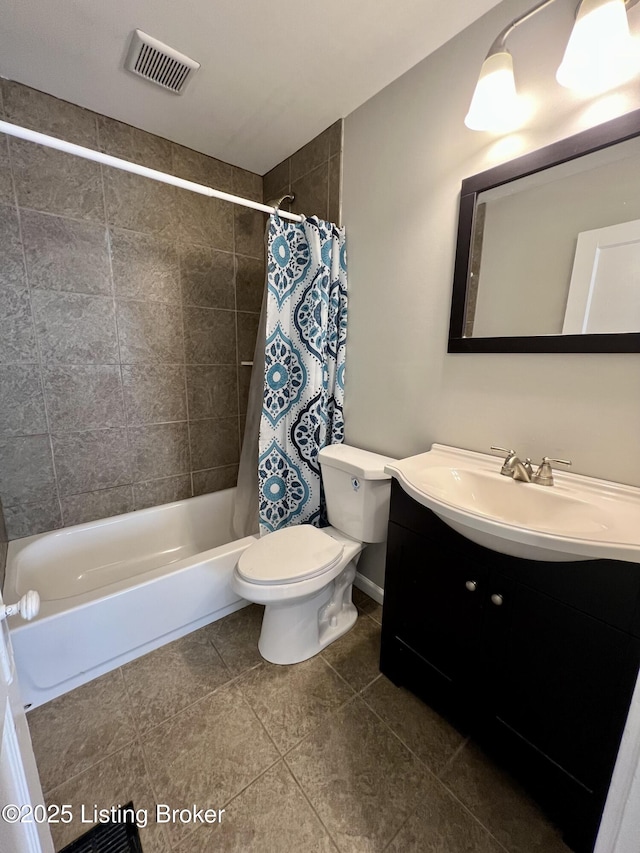 full bathroom with visible vents, toilet, shower / bath combo with shower curtain, vanity, and tile patterned floors