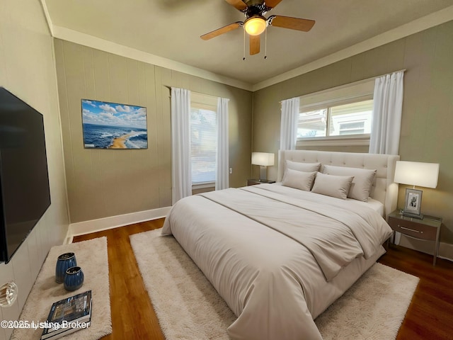 bedroom featuring wood finished floors, a ceiling fan, and baseboards