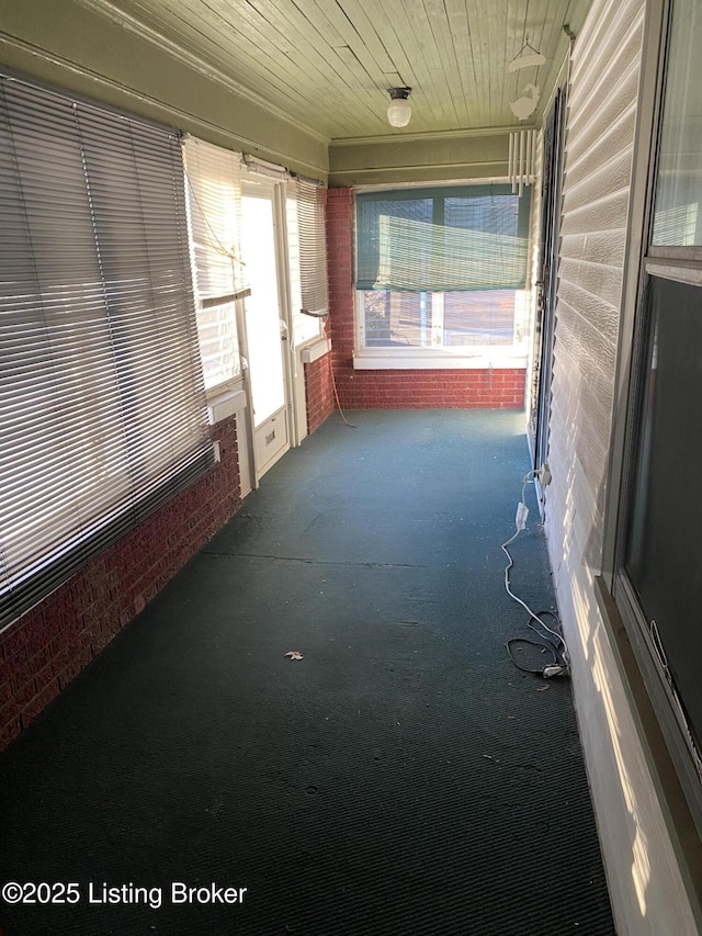 unfurnished sunroom with wood ceiling