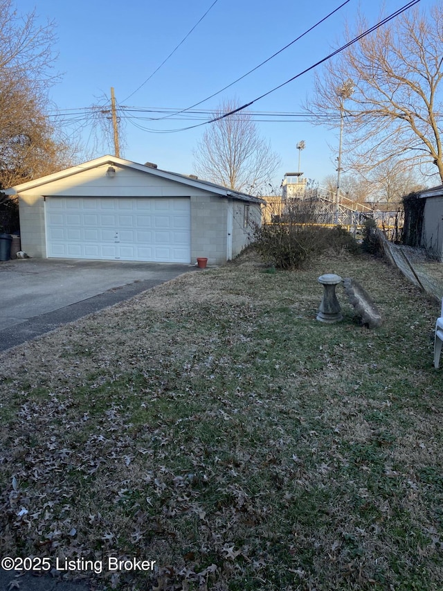 view of yard with a garage and an outbuilding