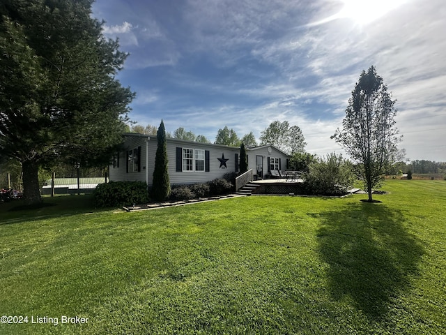 view of front facade featuring a front lawn and a deck