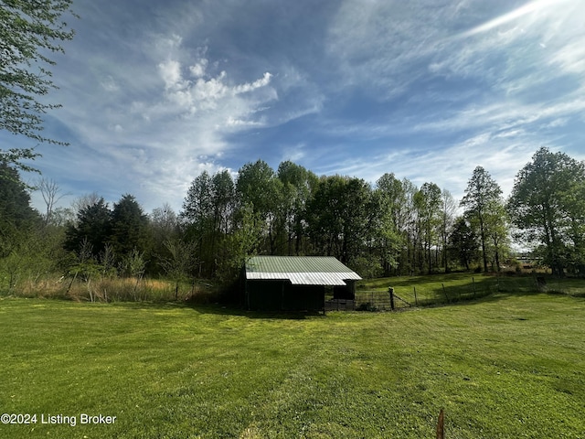 view of yard featuring fence and an outdoor structure