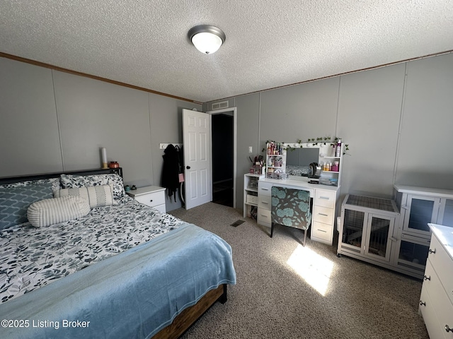 bedroom with ornamental molding, carpet, visible vents, and a textured ceiling