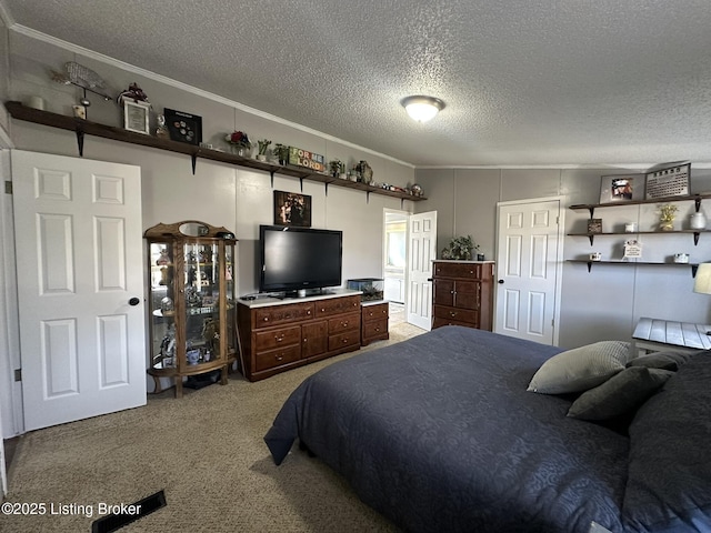 bedroom featuring carpet floors, crown molding, and a textured ceiling