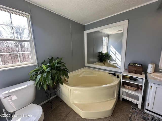 full bath featuring a textured ceiling, plenty of natural light, toilet, and tile patterned floors