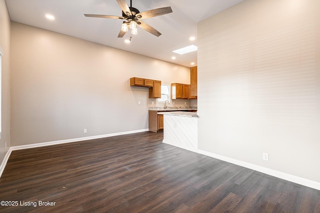 unfurnished living room featuring dark wood-type flooring, recessed lighting, a ceiling fan, and baseboards