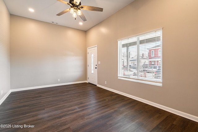 interior space featuring ceiling fan, visible vents, baseboards, and dark wood-style floors