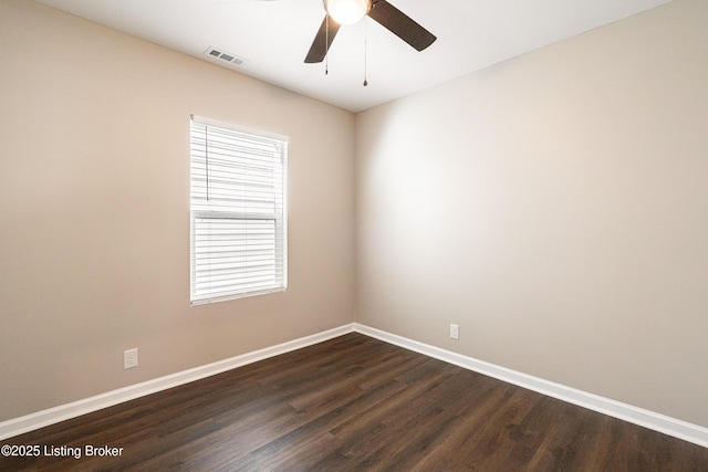 unfurnished room featuring visible vents, a ceiling fan, dark wood-type flooring, and baseboards