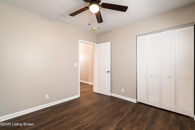 unfurnished bedroom with a ceiling fan, visible vents, baseboards, dark wood-style flooring, and a closet