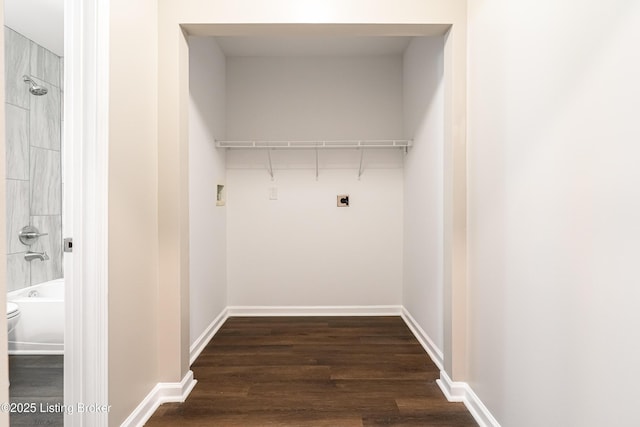 laundry area with dark wood finished floors, laundry area, baseboards, and hookup for an electric dryer