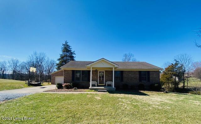 view of front of house with covered porch, a front lawn, concrete driveway, a garage, and brick siding