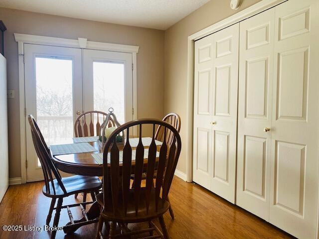 dining room with baseboards and wood finished floors