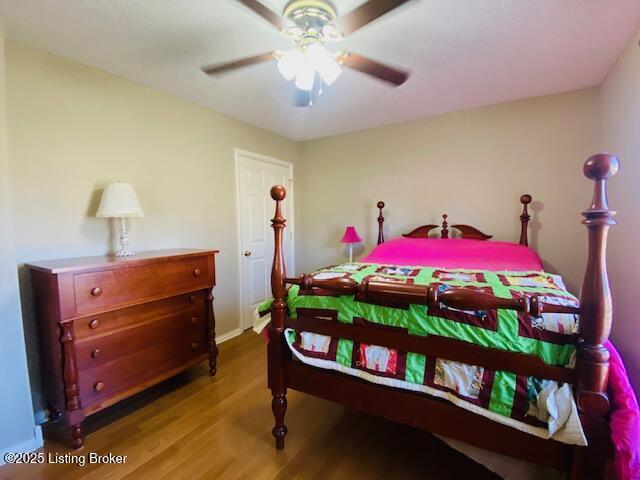 bedroom with wood finished floors and a ceiling fan