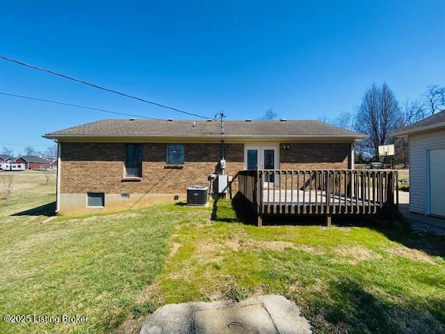 back of house featuring a yard, cooling unit, brick siding, and a deck