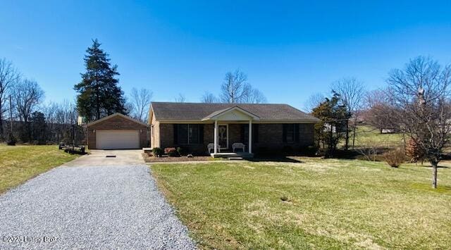 single story home with a garage, a porch, an outdoor structure, and a front yard