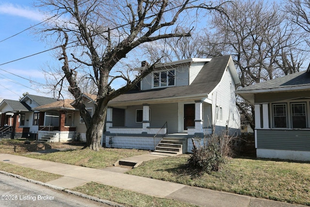 bungalow-style house featuring a porch and a front lawn