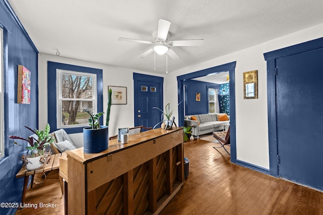 office space featuring a textured ceiling, ceiling fan, and hardwood / wood-style floors