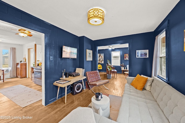 living room with a ceiling fan and wood finished floors